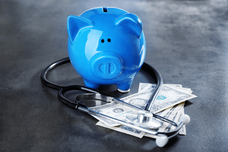 Group Healthcare Costs blue piggy bank and money 
